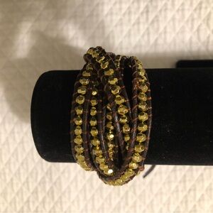 New. Imported Indonesian wrap bracelet. Handmade of leather, gold metal beads.